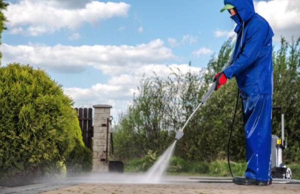 A Small Man With A Squeegee Window Cleaning